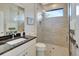 Modern bathroom with a large walk-in shower and granite vanity at 5221 Almar Dr, Punta Gorda, FL 33950