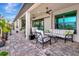 Relaxing covered patio with seating area, ceiling fans, and paver stones at 5221 Almar Dr, Punta Gorda, FL 33950