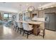 Modern kitchen with granite island, stainless steel appliances, and light gray cabinets at 5221 Almar Dr, Punta Gorda, FL 33950