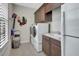 Bright laundry room with washer, dryer, and storage cabinets at 5221 Almar Dr, Punta Gorda, FL 33950