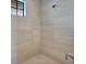 Spacious walk-in shower with neutral tile and window at 5221 Almar Dr, Punta Gorda, FL 33950