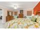 Main bedroom with floral bedding and a dresser at 616 Cherrywood Dr, Englewood, FL 34223