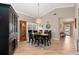 Bright dining room featuring a spacious table and hardwood flooring at 616 Cherrywood Dr, Englewood, FL 34223