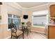 Kitchen nook with glass-top table and two chairs, overlooking the backyard at 616 Cherrywood Dr, Englewood, FL 34223