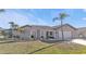 Single story home with tile roof, attached garage, and palm trees at 638 Andros Ct, Punta Gorda, FL 33950