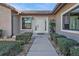 Front entry with walkway, landscaping, and white door at 638 Andros Ct, Punta Gorda, FL 33950