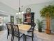 Dining room with dark wood table and chairs, hutch, and potted plants at 7083 Mifflin St, Englewood, FL 34224