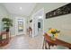 Bright entryway with tile flooring, console table, and plant decor at 7083 Mifflin St, Englewood, FL 34224