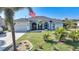 Single-story house with palm trees and a neatly manicured lawn at 7083 Mifflin St, Englewood, FL 34224