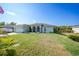 Light teal single story house with a screened porch at 7083 Mifflin St, Englewood, FL 34224