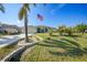 One-story home with landscaped lawn and attached garage at 7083 Mifflin St, Englewood, FL 34224