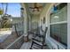 Screened porch with rocking chairs and ceiling fan at 7083 Mifflin St, Englewood, FL 34224