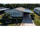 Single-story home with carport and landscaped yard at 805 Manchester Ct, Englewood, FL 34223