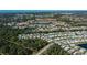 Aerial view of a large community with numerous homes and lush landscaping at 805 Manchester Ct, Englewood, FL 34223