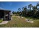 Landscaped backyard with lush green grass at 805 Manchester Ct, Englewood, FL 34223