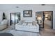 Bright living room featuring a white couch and sliding glass doors at 805 Manchester Ct, Englewood, FL 34223