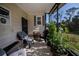 Screened porch with comfortable seating and potted plants at 805 Manchester Ct, Englewood, FL 34223