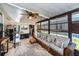 Relaxing sunroom with wicker furniture and tropical plants at 805 Manchester Ct, Englewood, FL 34223