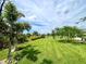 Landscaped backyard with lush green grass and tropical plants at 8117 Thruso Rd, Port Charlotte, FL 33981