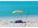 Beach scene with colorful umbrella at 8117 Thruso Rd, Port Charlotte, FL 33981