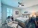 Bedroom with a queen bed, ceiling fan, and an armchair at 8117 Thruso Rd, Port Charlotte, FL 33981