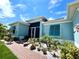 House exterior showcasing teal shutters and a landscaped walkway at 8117 Thruso Rd, Port Charlotte, FL 33981