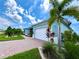 House exterior showcasing a light blue color, white garage door, and landscaping at 8117 Thruso Rd, Port Charlotte, FL 33981