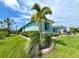 Side view of a light blue house with tropical landscaping at 8117 Thruso Rd, Port Charlotte, FL 33981