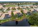 Aerial view of property with screened-in pool overlooking a pond at 8242 Lakeside Dr, Englewood, FL 34224