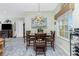 Cozy dining area featuring a round table, wood chairs, and a decorative chandelier at 8242 Lakeside Dr, Englewood, FL 34224