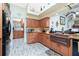 Beautiful kitchen featuring wooden cabinets, granite countertops, and an adjacent breakfast bar at 8242 Lakeside Dr, Englewood, FL 34224