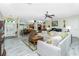 Bright living room with tile floors, neutral paint, and an open floor plan leading to the kitchen at 8242 Lakeside Dr, Englewood, FL 34224