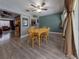 Dining room with wooden table and chairs, view into living room at 939 Silver Springs Nw Ter, Port Charlotte, FL 33948