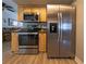 Kitchen with stainless steel appliances and light wood cabinets at 939 Silver Springs Nw Ter, Port Charlotte, FL 33948