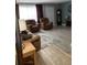 Living room with brown leather armchairs and a wood-look floor at 939 Silver Springs Nw Ter, Port Charlotte, FL 33948