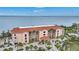 Waterfront building with a terracotta roof and lush landscaping at 95 N Marion Ct # 233, Punta Gorda, FL 33950