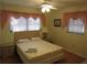 Bright bedroom with double bed, two windows, and light flooring at 120 Rodgers Ne Ave, Port Charlotte, FL 33952