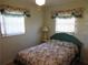 Bedroom with a teal bed frame and floral bedding at 120 Rodgers Ne Ave, Port Charlotte, FL 33952