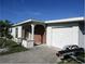 House exterior showcasing a brick facade and attached garage at 120 Rodgers Ne Ave, Port Charlotte, FL 33952