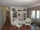 Living room with built-in shelving and two wicker armchairs at 120 Rodgers Ne Ave, Port Charlotte, FL 33952