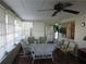 Sunroom with white wicker furniture and tiled floor at 120 Rodgers Ne Ave, Port Charlotte, FL 33952