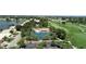 Aerial view of community with tennis courts, pool, and golf course at 10214 Windsong Rd, Punta Gorda, FL 33955