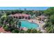 Community pool and tennis courts with a pool house at 10214 Windsong Rd, Punta Gorda, FL 33955