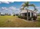 Home features a large backyard, lush landscaping, and screened patio at 10214 Windsong Rd, Punta Gorda, FL 33955