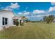 Landscaped backyard with grassy area and partial home view at 10214 Windsong Rd, Punta Gorda, FL 33955