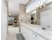 Double vanity bathroom with a view into the bedroom at 10214 Windsong Rd, Punta Gorda, FL 33955