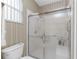 Clean bathroom with a large shower and updated toilet at 10214 Windsong Rd, Punta Gorda, FL 33955