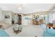 Bright dining area with glass-top table and four chairs, adjacent to kitchen at 10214 Windsong Rd, Punta Gorda, FL 33955