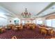 Community clubhouse dining room with tables, chairs, and chandeliers at 10214 Windsong Rd, Punta Gorda, FL 33955