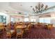 Community clubhouse dining room with tables, chairs, and chandeliers at 10214 Windsong Rd, Punta Gorda, FL 33955